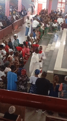 Church service with traditional dress and diverse congregation documented