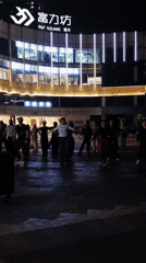 Evening group dance gathering at Chongqing R&F Square plaza