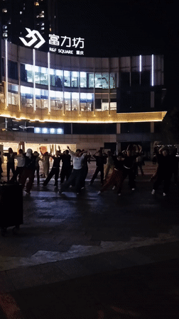 Evening group dance gathering at Chongqing R&F Square plaza