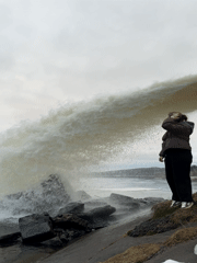 Woman photographs herself at Chernushka waterfall during afternoon visit