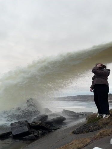 Woman photographs herself at Chernushka waterfall during afternoon visit