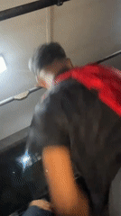 Young man dances energetically in vehicle in Los Robles, Venezuela