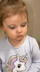 Mother and toddler play with makeup in Russian home