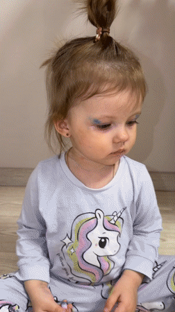 Mother and toddler play with makeup in Russian home