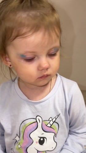 Mother and toddler play with makeup in Russian home