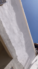Worker performs building maintenance on rooftop in Jos, Nigeria