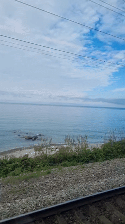 Train passenger captures coastal view near Sochi, Russia