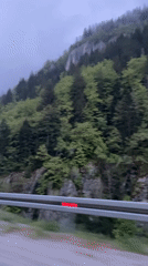 Vehicle travels through foggy forested hills in Montenegro