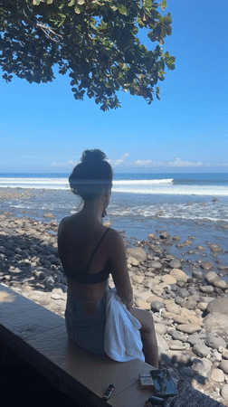 Woman enjoys early morning ocean view at Pekutatan beach