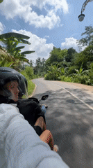 Scooter rider observed on paved road in Gianyar