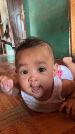 Baby at home in Kruengmate, with a meal close by