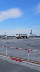 Passengers board aircraft at Reus Airport under sunny skies