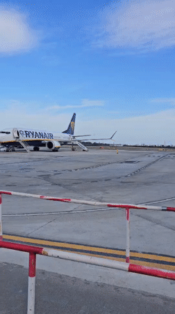Passengers board aircraft at Reus Airport under sunny skies
