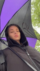Woman walks with umbrella through rainy Liepaja streets