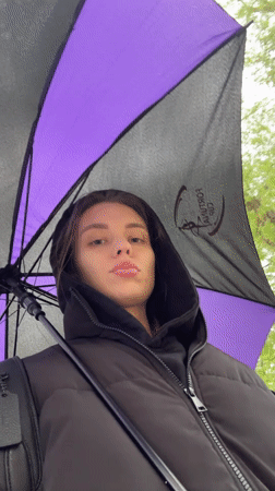 Woman walks with umbrella through rainy Liepaja streets