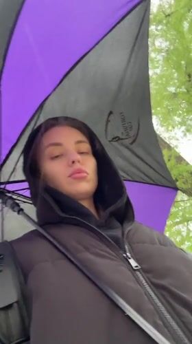 Woman walks with umbrella through rainy Liepaja streets