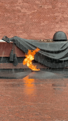 Eternal flame memorial with military helmet observed in rainy Moscow