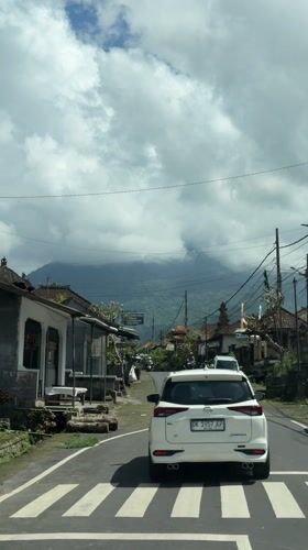 Vehicle recorded driving through narrow street in Penebel, Indonesia