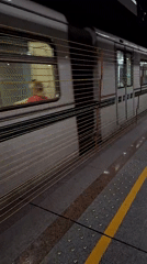 Silver metro train passes through Sofia station platform
