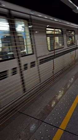 Silver metro train passes through Sofia station platform