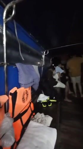 Passengers travel aboard longtail boat in Ban Ao Nang