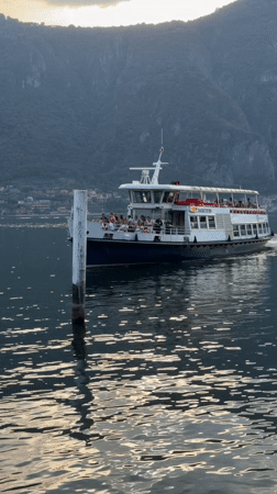 Ferry crossing Lake Como near Mandello del Lario on a clear afternoon