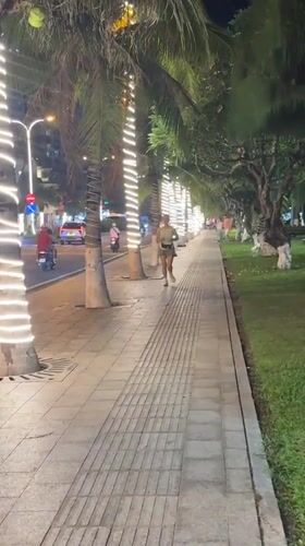Evening activity captured along lit Nha Trang waterfront walkway
