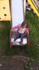 Child plays at playground amid spring blooms in Berezniki