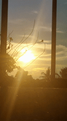 Golden sunset viewed through barred windows in Thailand