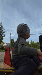 Toddler plays at Chaikovsky playground on a September morning