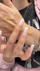 Person tests gold glittery cosmetics in Saint Petersburg