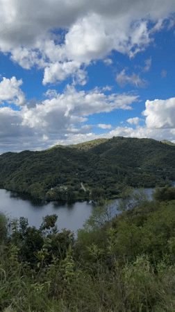 Blue lake and green hills captured in La Estancia