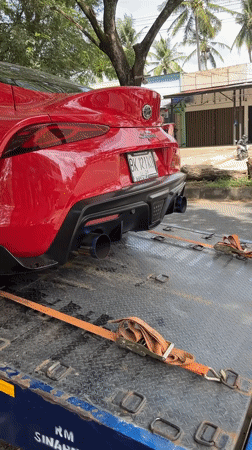 Modified Toyota Supra towed on roadside in Indonesia