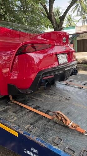Modified Toyota Supra towed on roadside in Indonesia