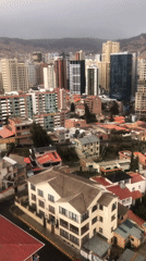 Aerial footage captures La Paz cityscape under overcast evening sky