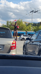 Street performer juggles for traffic in Sofia intersection