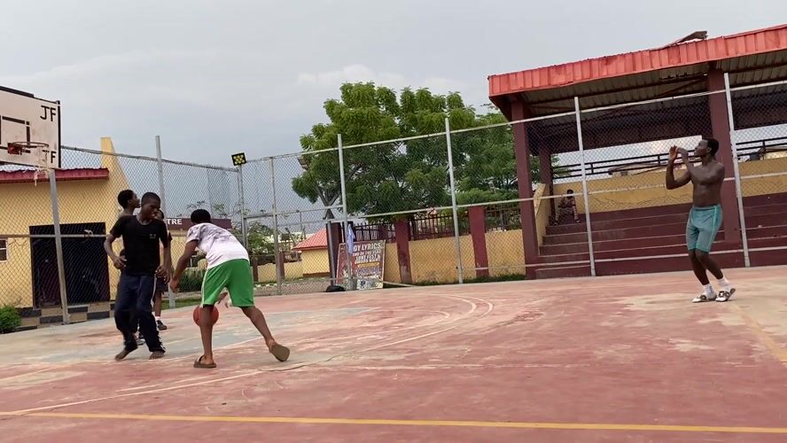 Young men play basketball at Lagos youth center court