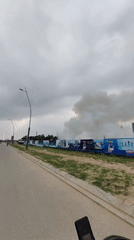 Smoke plume rises behind construction site in Bai Chay Ward
