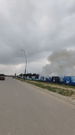 Smoke plume rises behind construction site in Bai Chay Ward
