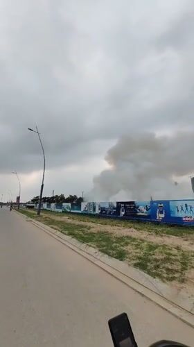Smoke plume rises behind construction site in Bai Chay Ward
