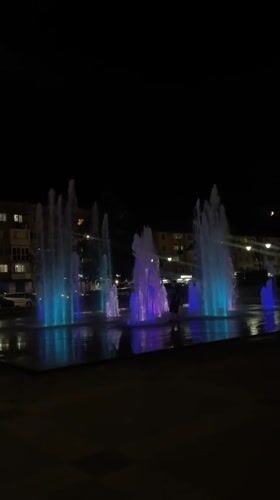 Cherkessk fountain glows at night in purple and blue