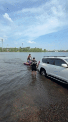 Custom jet ski and submerged SUV on a Krasnoyarsk riverbank