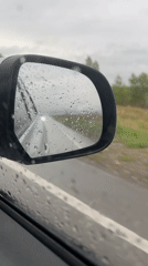 Vehicle travels through rainy conditions in Sayanogorsk, Russia