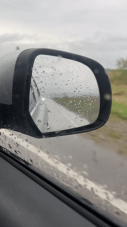 Vehicle travels through rainy conditions in Sayanogorsk, Russia