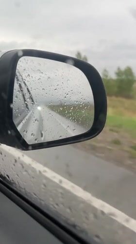 Vehicle travels through rainy conditions in Sayanogorsk, Russia