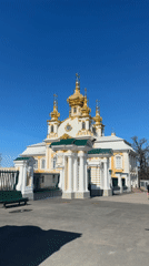 Tourist captures Peterhof Palace fountains on sunny spring day