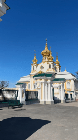 Tourist captures Peterhof Palace fountains on sunny spring day