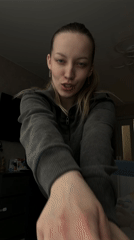 Woman recorded smiling, gesturing cheerfully indoors in Reshetnikovo