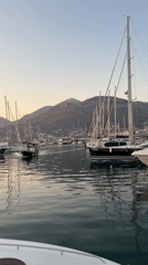 Bar harbor at golden hour: fishing boats, nets, and moored yachts