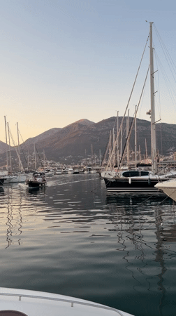 Bar harbor at golden hour: fishing boats, nets, and moored yachts
